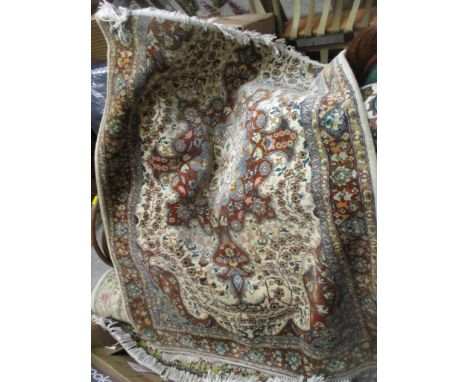 An Indian hand woven rug, central floral motif, all over floral designs on a white, terracotta and light blue ground, multi g