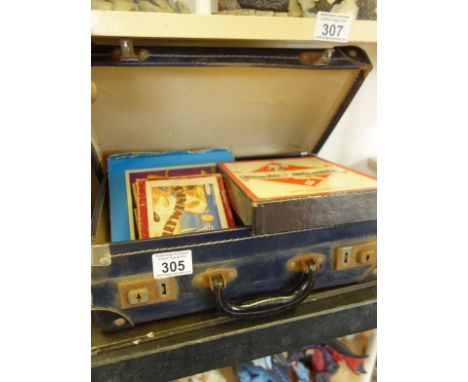 Old suitcase containing old children’s games including cribbage board, monopoly