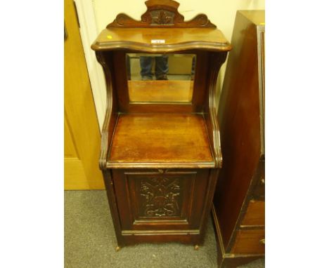 Late 19c mahogany coal unit, the door with a fall front, mirrored back and small parcel shelf on castors