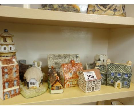 Shelf of miniature cottages many by John Putnans