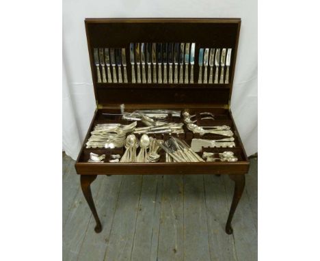 Canteen of silver plated Kings pattern flatware in a fitted table cabinet the hinged cover with tooled leather top