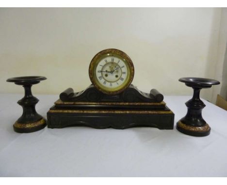 Black marble mantle clock, circular enamel dial with Roman numerals and two train movement flanked by two matching tazzas