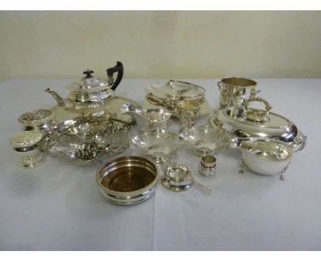 A quantity of silver plate to include an entree dish and cover, sauce boats, teapot, wine bottle coaster, fruit dishes and ca