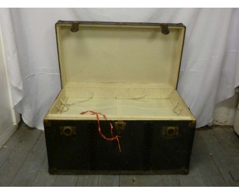 Metal bound steamer trunk, linen lined interior with hinged cover and key