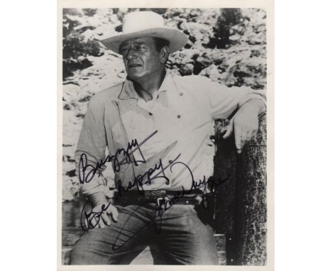 WAYNE JOHN: (1907-1979) American Actor, Academy Award winner. Signed and inscribed 8 x 10 photograph of Wayne standing outdoo