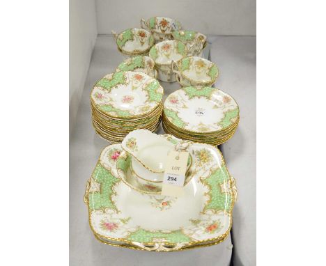 Coalport part tea service, decorated with partial borders of green and gilt, interspaced by roses, lilies and pansies, compri