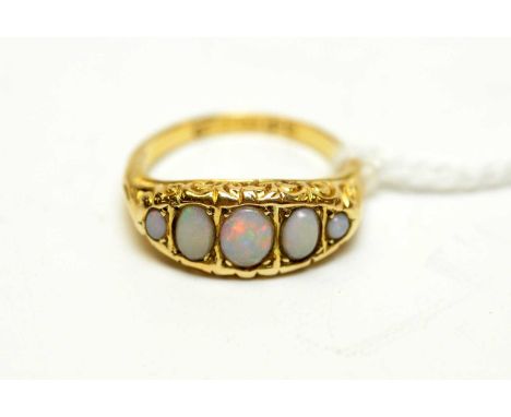 An antique 18ct gold and opal dress ring, the face pellet-set with five graded opals within square cells, 2.3g