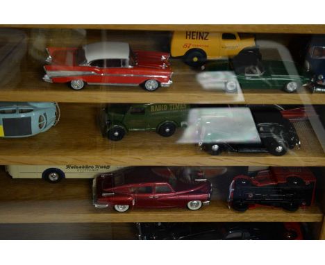 Selection of loose die-cast model vehicles, contained across two glazed stained wood wall mounting display shelves; along wit