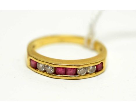 A contemporary 18ct gold, ruby, and diamond ring, the stepped face captive-set with a row of alternating pairs of round-cut d