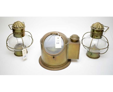 20th-century Sestrel brass ships compass, 26cms wide; and a pair of brass ships lamps. (3)