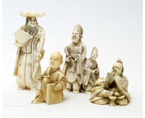 Four Japanese ivory netsuke, comprising two carved as figures of gentlemen, and two figure groups, the largest 67 mms high.