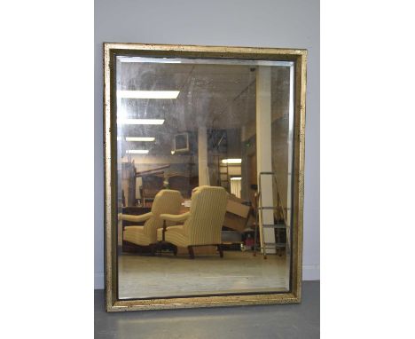 A 20th Century wall mirror, the bevelled mirror plate contained within a silver painted frame, 102 x 133cms; 20th Century wal