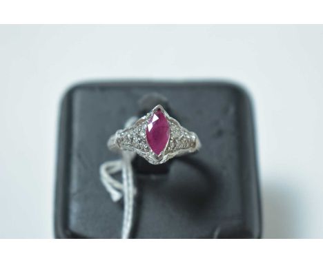 A contemporary 14ct white gold, ruby and diamond cocktail ring, of Gothic influence, having a central navette-cut ruby held a