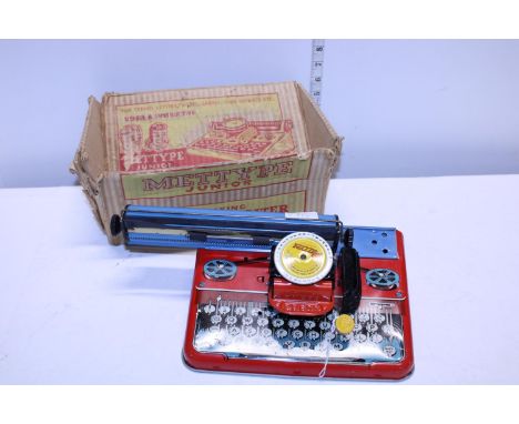 A vintage Mettype junior tin plate typewriter in original box 