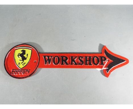 A cast iron arrow workshop sign, Ferrari, approx 42 cm x 12 cm ( yazfe)