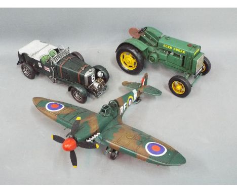 Three unboxed large scale decorative models depicting a Bentley Blower; a Spitfire and a John Deere Tractor.