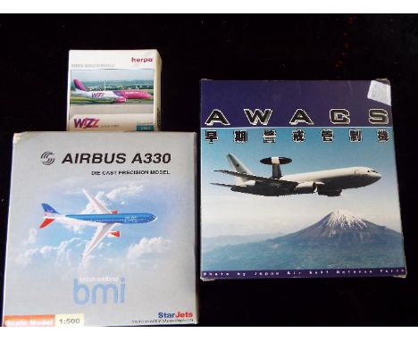 Three 1:500 scale model aircraft, Herpa, StarJets and Awacs, appear m in b