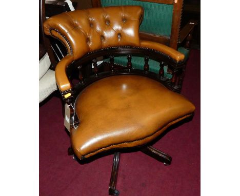 A contemporary mahogany tan leather buttoned upholstered and further studded tub swivel desk chair, width 64cmLeather is good