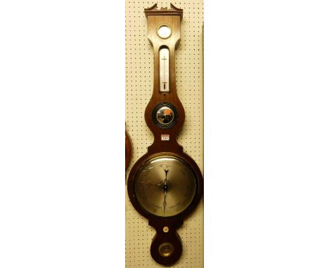 A reproduction mahogany four-dial wheel barometer