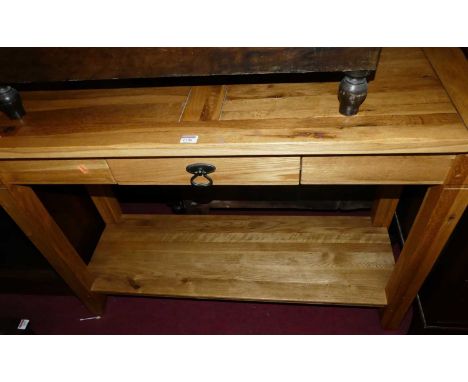 A contemporary light oak two-tier single drawer hall table, w.110cm 