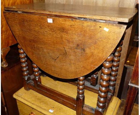 An 18th century joined and bobbin turned oak gateleg occasional table, having single end drawer