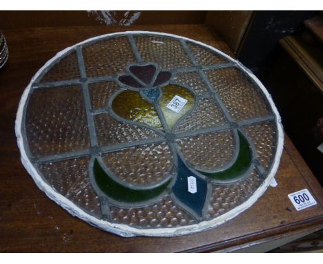 A vintage circular stained glass panel with Fleur de lys decoration