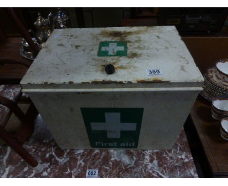 A vintage metal first aid box with carrying handles 