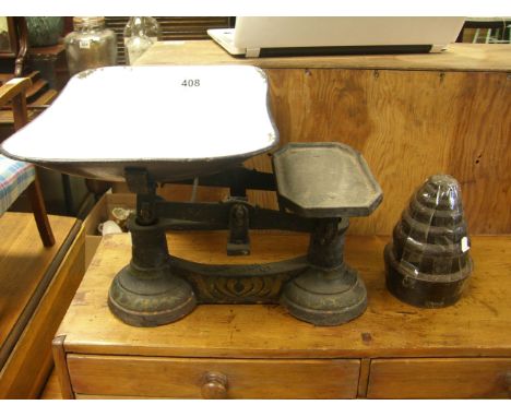 A set of vintage cast iron scales with pan and weights.