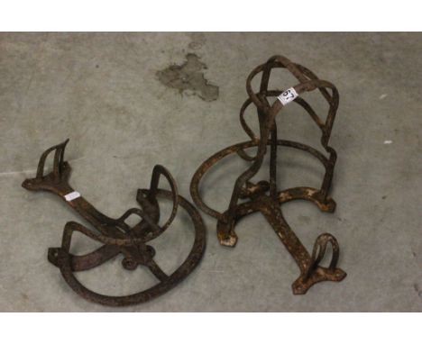 Two vintage cast iron saddle racks