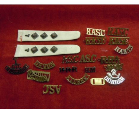 WWI Brass Shoulder titles and epaulets, includes: Devon,  Royal Honourable Artillery, Army Service corps and an officers mess