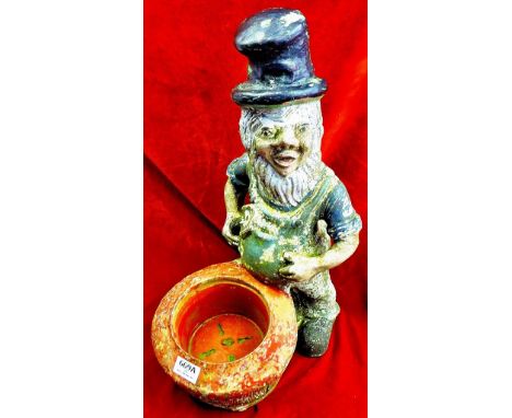 A painted gnome with top hat and trowel. Weathered Caste Concrete.