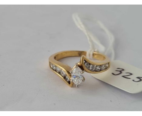 14ct diamond set crossover ring with diamond set shoulders andA central marquise diamond weighing approx 0.40cts, size