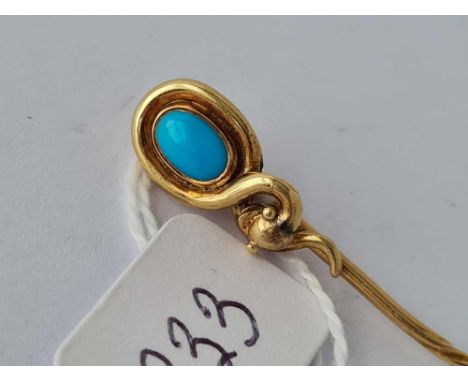 A fine snake swirled Victorian stick pin with oval turquoise in high carat gold