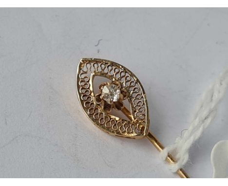 A stick pin 14ct gold with diamond top