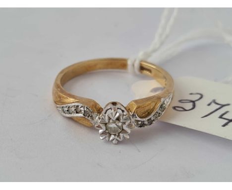 A solitaire diamond ring with diamond shoulders 9ct size L   