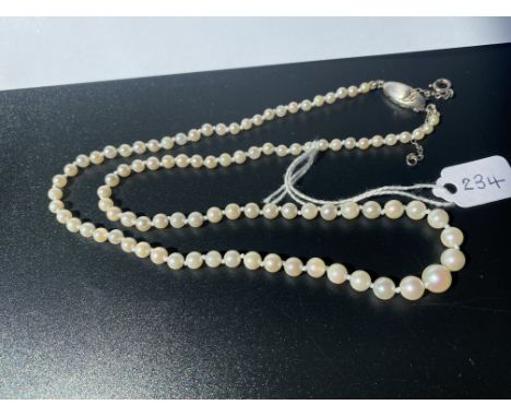 A pearl necklace of fine white graduated pearls set with 18ct gold diamond snap