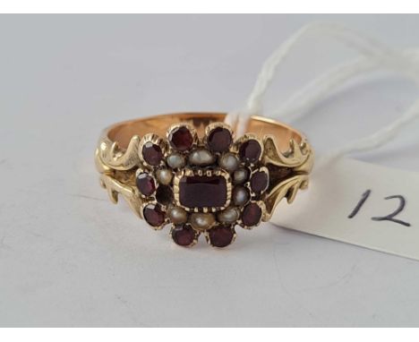 A antique garnet and pearl ring set in gold size T      3.7 gms