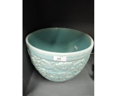 A vintage ceramic planter with impressed floral decor and green glaze