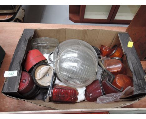 A box of vintage car light glass etc