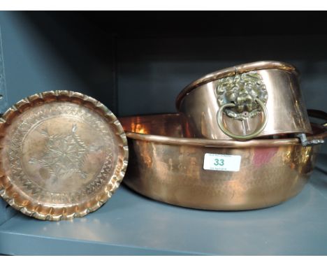 A selection of vintage copper items including lion head and footed planter