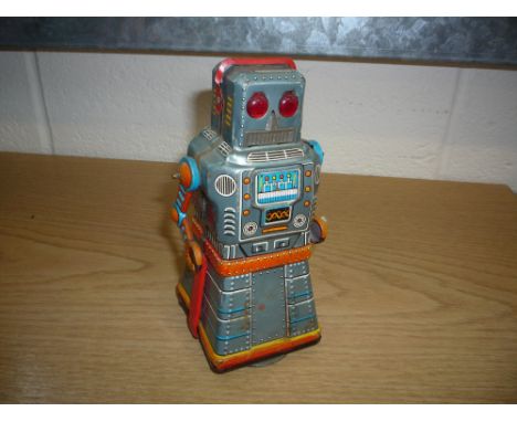 A KO (JAPAN) TINPLATE CLOCKWORK ROBOT, lithograph body, working mystery action to base, some damage/wear and minor paint loss