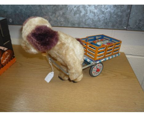 AN UNBOXED ALPS TINPLATE BATTERY OPERATED WALKING DOG AND CART, not tested, plush dog pulling a lithograph tinplate cart, som