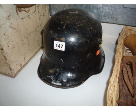GERMAN WWI ERA ARMY HELMET, in black with internal head pads etc