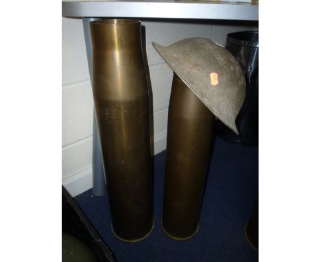 A BRITISH WWI/WWII ARMY HELMET, with interior strap head pads etc and two large Artillery shell cases approximately 2' 6' tal