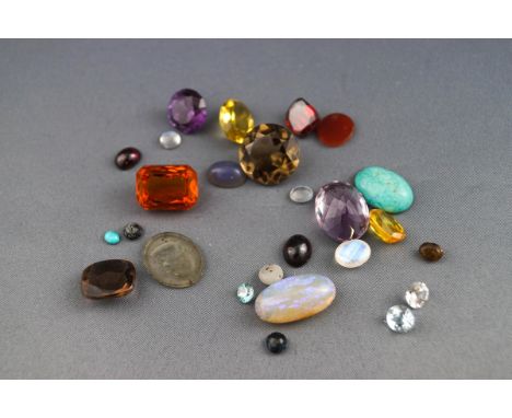 A selection of loose gemstones to include smokey Quartz, amethyst, Garnet, Opal, Amazonite, Synthetic corundum and paste