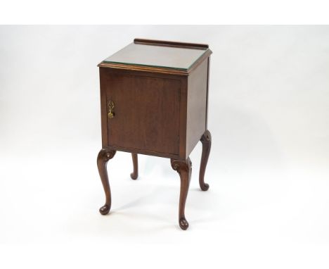 A mahogany bedside cabinet on cabriole legs with one cupboard door, 74cm high x 40cm wide x 40cm deep