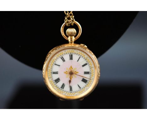 A stamped 14K open face pocket watch. Foliate and scroll engraved case with ceramic dial having a central floral motif. Manua