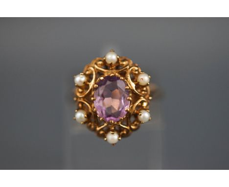 A 9 carat gold amethyst and seed pearl abstract cluster ring, Hallmarked 9ct, London. 5.2 grams boxed