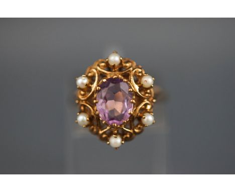 A 9 carat gold amethyst and seed pearl abstract cluster ring, Hallmarked 9ct, London. 5.2 grams boxed