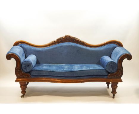 A Victorian mahogany show frame sofa with arched back, scroll arms and turned legs, 200cm wide